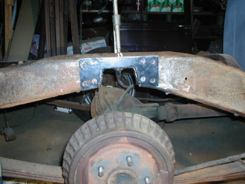 1998 Ford Taurus - Close-up of a vehicle's rear frame section with a newly attached metal bracket.