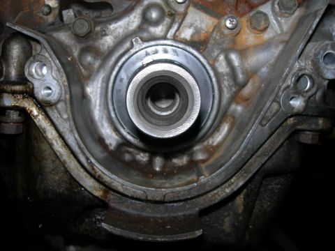 1992 Ford Taurus - This image shows the crankshaft seal housing on an engine, likely needing replacement due to wear.
