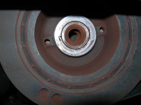 1992 Ford Taurus - Close-up of a rusty crankshaft pulley, showing a metal keyway for alignment.