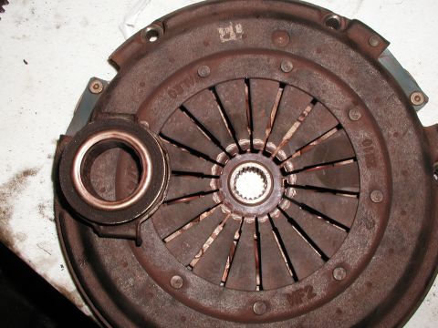 1992 Ford Taurus - Close-up of a used clutch pressure plate and release bearing, showing wear and rust.