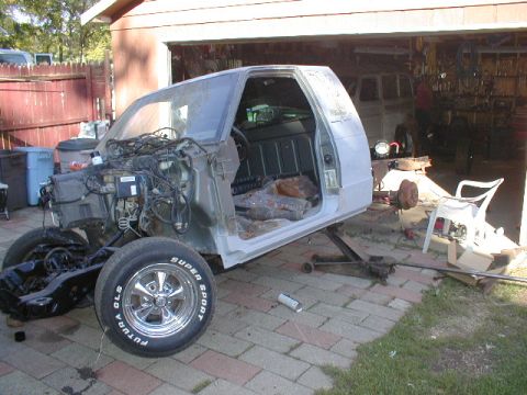 1998 Ford Taurus - This pickup truck body is undergoing repairs, with its engine bay and interior exposed.