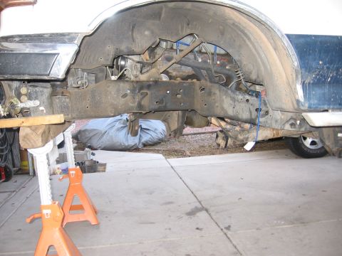 1990 Ford Bronco - Close-up view of a vehicle's undercarriage, showing the frame and suspension system.