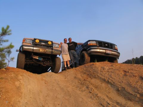 1993 Ford Bronco - Two men pose with their Ford Bronco and another Ford truck on a dirt hill.