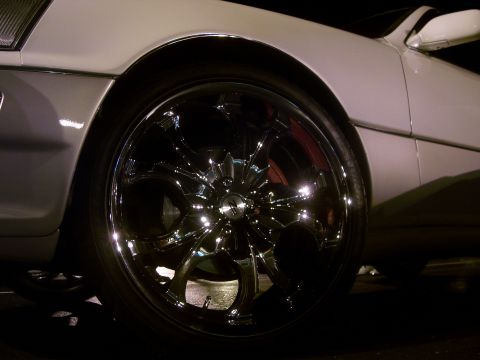 1994 Ford Probe - Close-up of a shiny chrome wheel and tire on a white vehicle.