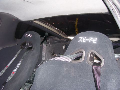 1994 Ford Probe - Custom racing seats with Japanese lettering and NISMO branding are visible inside the vehicle's interior.