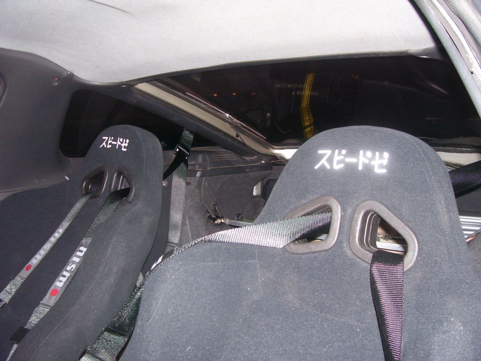 Interior view of racing seats with Japanese text and NISMO branding
