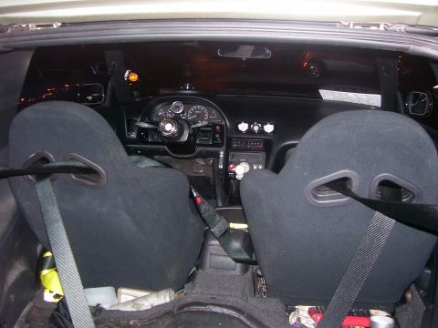 1994 Ford Probe - Custom interior features racing seats and aftermarket gauges, but year is not identifiable.