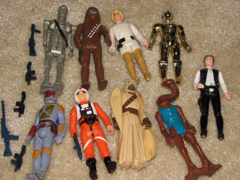 1991 Ford Bronco - Several Star Wars action figures and their accessories are laid out on a carpeted surface.