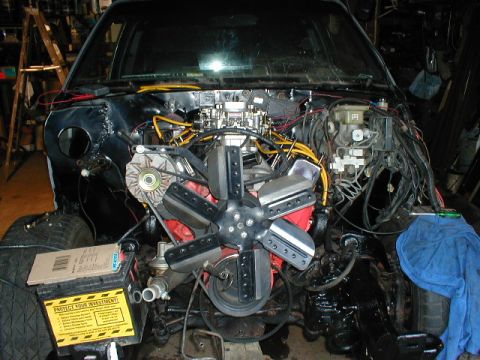1998 Ford Taurus - Car's engine bay is empty, revealing the internal components and wiring before engine installation.