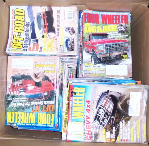 1978 Ford Bronco - A collection of automotive magazines is piled inside a cardboard box.