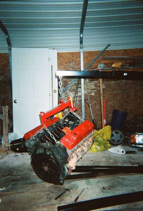 1988 Ford Bronco - Engine teardown in progress, showing the engine being lifted out of a vehicle.