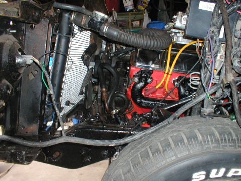 1998 Ford Taurus - Close-up view of an engine bay, showing the engine block, radiator, and part of a tire.