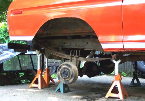 1978 Ford Bronco - Rear axle and suspension of a 1978 Ford Bronco being worked on, supported by jack stands.
