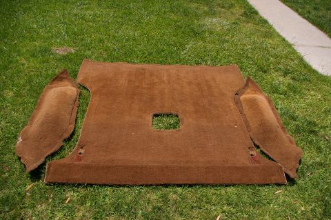 1986 Ford Bronco - Brown car headliner and side panels are displayed on a grassy lawn.