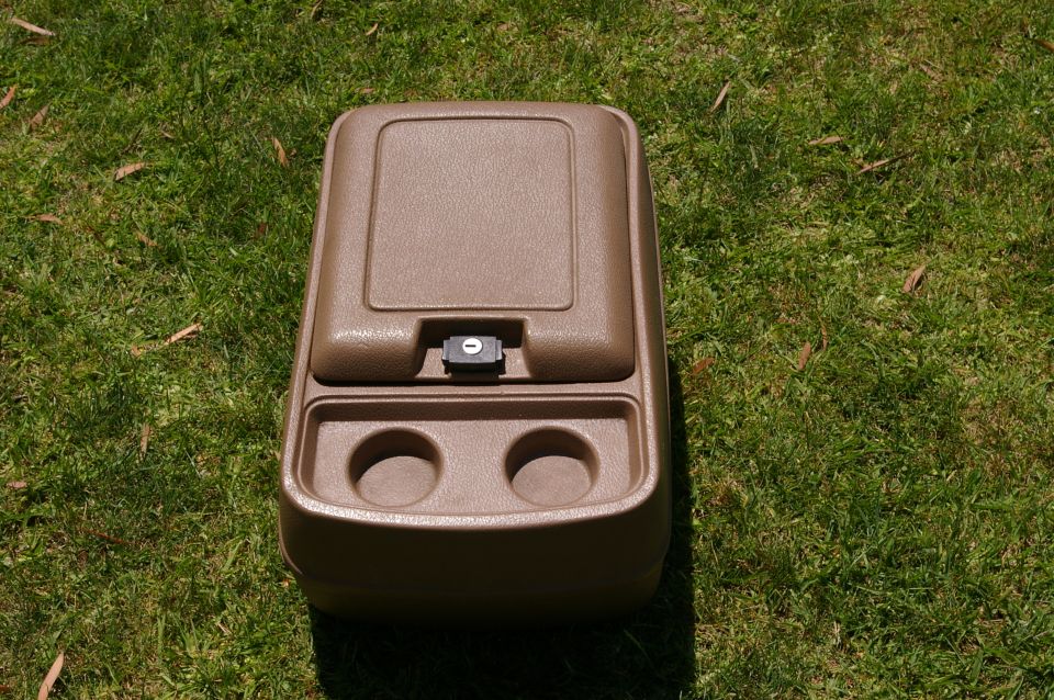 Brown plastic center console with two cup holders and a latching lid