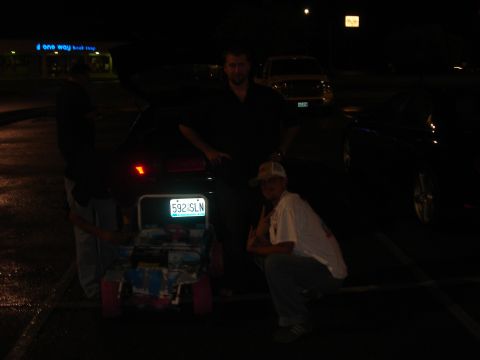 1996 Ford Probe - A toy car with a license plate is displayed in front of a dark vehicle.