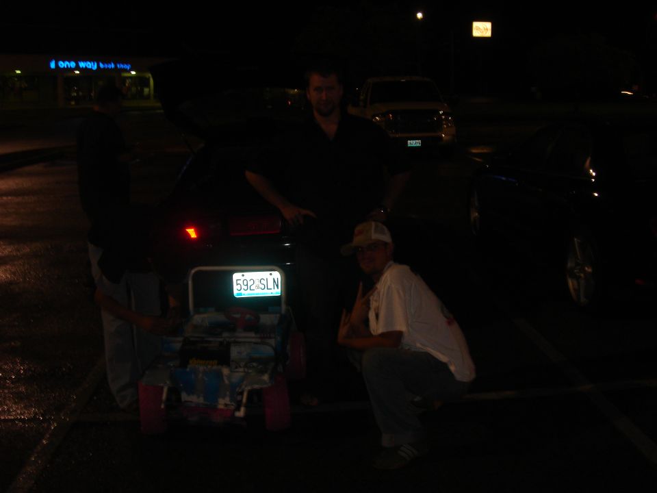 Night parking-lot photo of people behind a GT hatchback with hatch open