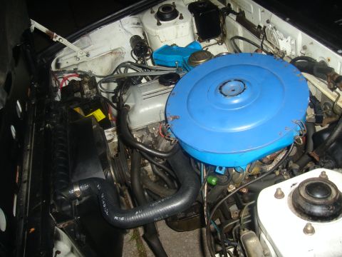 1997 Ford Probe - The engine bay of a vehicle is shown, with a prominent blue air filter housing.