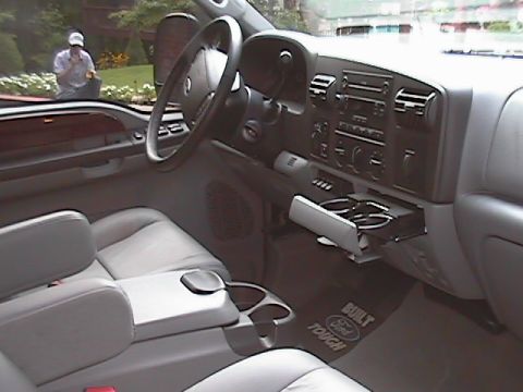 2005 Ford F-250 - The interior of a 2005 Ford F-250, gray leather seats and a "Built Ford Tough" floor mat.