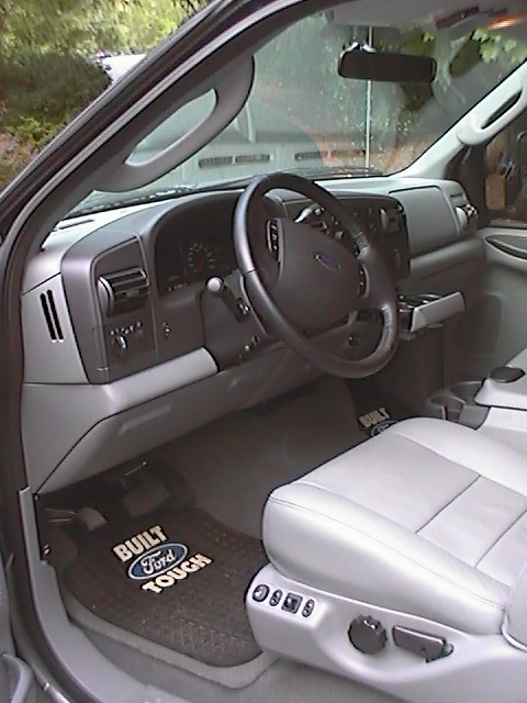 2005 Ford F-250 - The interior of a Ford F-250 truck, the driver's side controls and seating area.