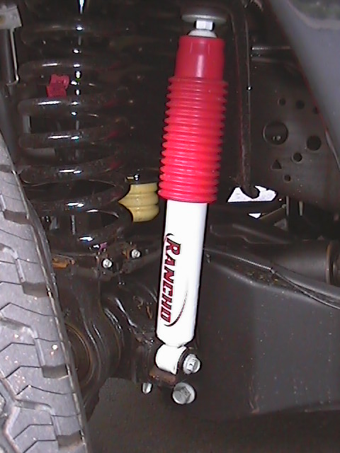 2005 Ford F-250 - Close-up view of a Rancho shock absorber and suspension components, indicating aftermarket parts.