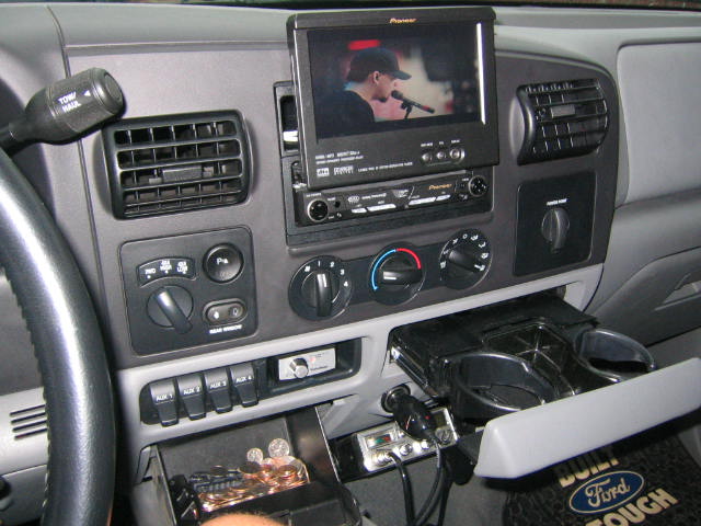 Ford truck dash with Pioneer flip-out screen, manual climate dials and CB radio