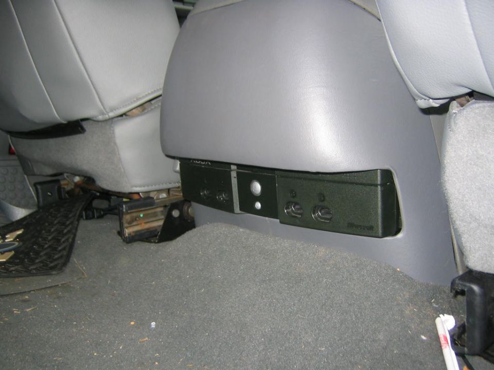 Rear-seat air vent and control panel on the back of gray truck front seats