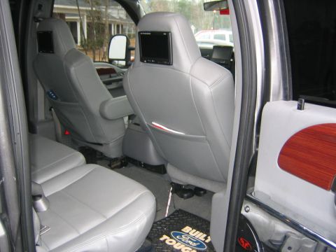 2005 Ford F-250 - The interior of a 2005 Ford F-250 features gray leather seats and entertainment screens mounted on the headrests.