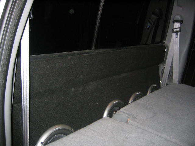 interior view of a subwoofer box with three speakers installed