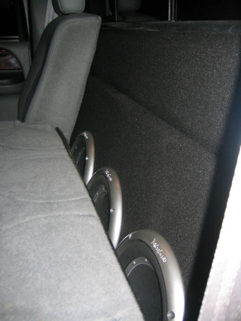 2005 Ford F-250 - Subwoofer speakers are visible behind the seat of a vehicle.
