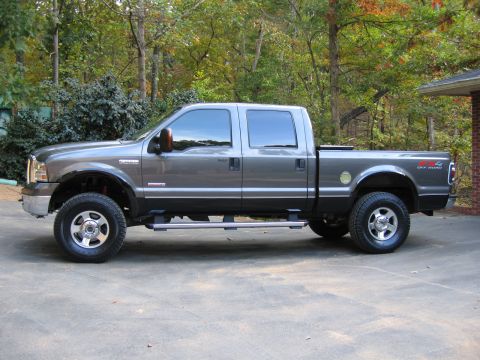 2005 Ford F-250 - Gray 2005 Ford F-250 Super Duty pickup truck, crew cab, long bed, lifted with aftermarket wheels and tires.
