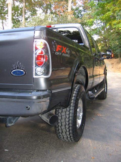 2005 Ford F-250 - This dark gray Ford F-250 truck features an FX4 Off Road decal and is equipped with large tires.