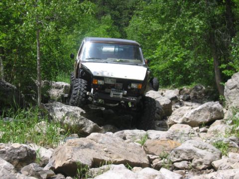 1981 Ford Bronco - This modified off-road vehicle is shown traversing a challenging rocky path.