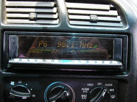 1994 Ford Probe - Close-up of a car's dashboard climate controls and a radio display.