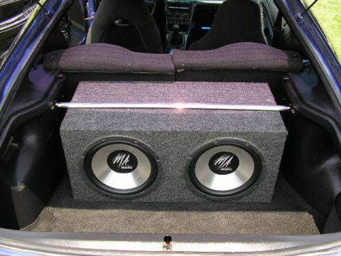 1994 Ford Probe - The trunk of a blue 1994 Ford Probe houses a dual subwoofer enclosure.