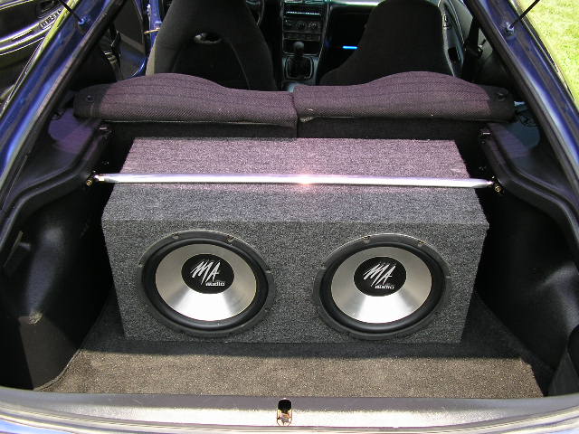 Blue 1994 Ford Probe trunk interior with dual MA Audio subwoofers in a grey carpeted box