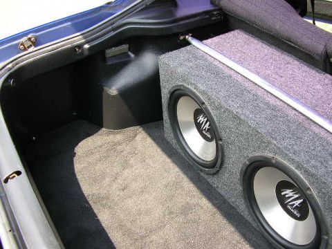 1994 Ford Probe - Subwoofer box installed in the trunk of a car, with a metal strut bar above it.