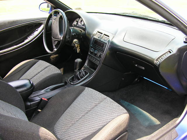 Interior of a 1994 Ford Probe GT, showing the dashboard, seats, and gear shifter