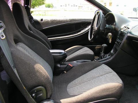 1994 Ford Probe - The interior of a 1994 Ford Probe shows its cloth seats, dashboard, and gear shifter.