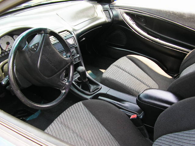 1994 Ford Probe interior with cloth seats, black dashboard, and steering wheel with 'PROBE' embossed