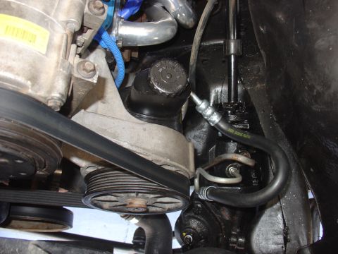 1988 Ford Bronco - Close-up view of engine components including the power steering pump and associated hoses.