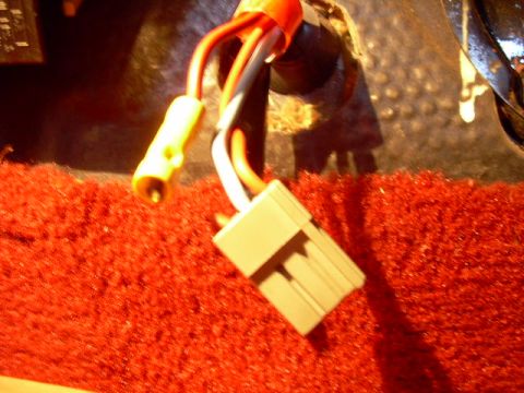 1984 Ford Bronco - Wiring harness connector and wires are visible against a textured red surface.