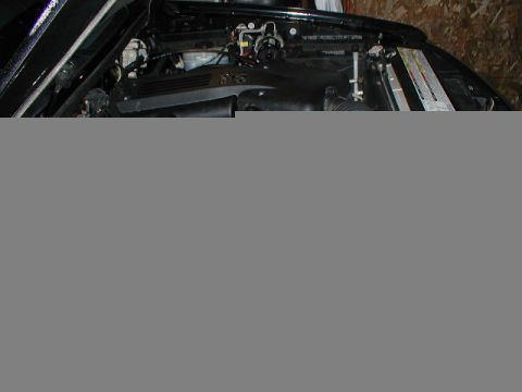 1998 Ford Taurus - The engine bay of a car is shown with various components and wiring.