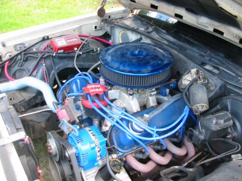 1985 Ford LTD Crown Victoria - Close-up view of a modified engine bay, highlighting various aftermarket components and wiring.