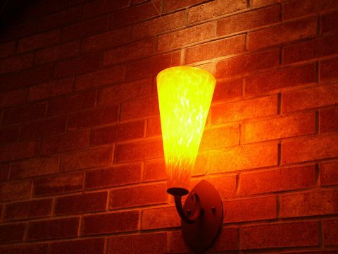 2001 Mercury Grand Marquis - A wall lamp with a patterned yellow glass shade illuminates a brick wall, with a Supermotors.net watermark at the bottom right.