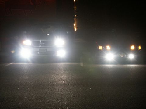 2001 Mercury Grand Marquis - Two cars parked at night with headlights illuminated.