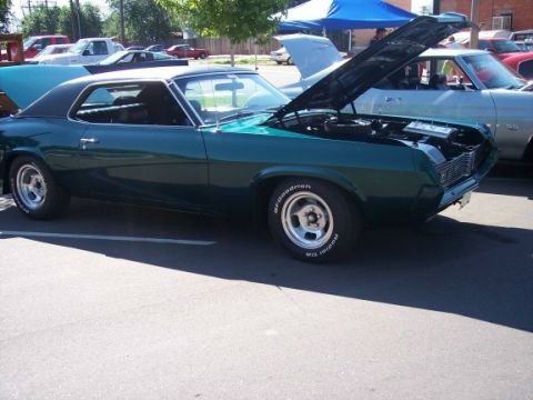 1972 Ford Ranchero - A green 1969 Mercury Cougar XR7 coupe is parked with its hood open, showing the engine bay.