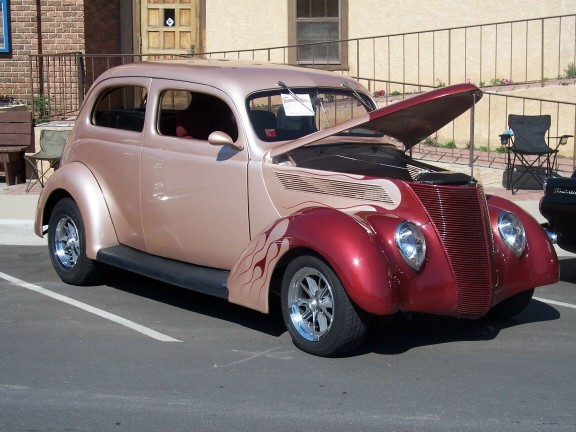 Two-tone hot rod with flames painted on the side and hood open