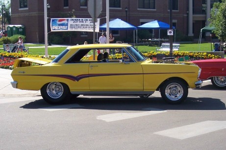 1972 Ford Ranchero - A bright yellow 1964 Chevrolet Nova is parked next to a red vehicle, with its hood open revealing the engine.