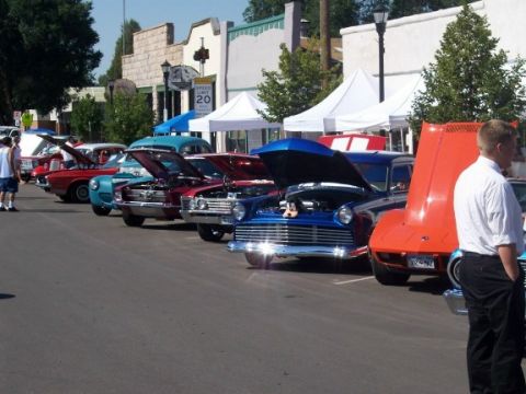 1972 Ford Ranchero - A lineup of vintage automobiles are displayed with their engines exposed at a sunny outdoor gathering.